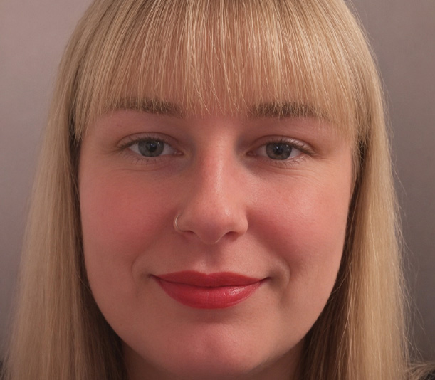 portrait of a woman with blonde hair and light makeup showcasing a serene expression wearing a nose ring bright lipstick and clear skin appealing for beauty four features