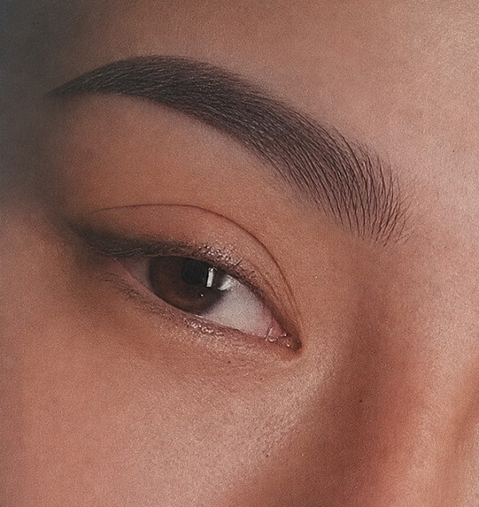 woman undergoing lip enhancement procedure with a professional applying treatment for fuller lips